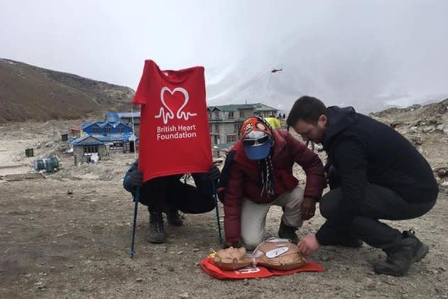 Life-saver: Justin Honey-Jones teaches local trekkers at Everest Base Camp in Nepal how to use a portable defibrillator: Sophie Goodchild