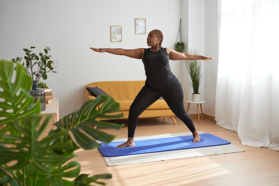 Another health benefit of stress-busting activities can be an increase in heart rate variability. <a href="https://www.gettyimages.com/detail/photo/woman-standing-on-yoga-mat-in-warrior-pose-while-royalty-free-image/1397801043" rel="nofollow noopener" target="_blank" data-ylk="slk:David Espejo/Moment via Getty Images;elm:context_link;itc:0;sec:content-canvas" class="link ">David Espejo/Moment via Getty Images</a>