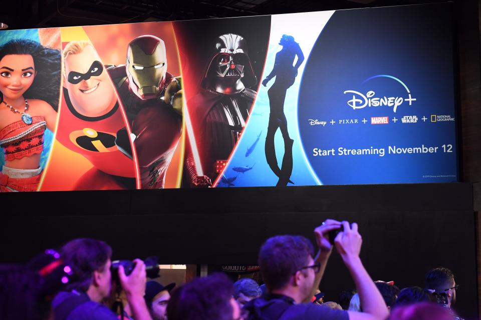 Attendees visit the Disney+ streaming service booth at the D23 Expo, billed as the "largest Disney fan event in the world," on August 23, 2019 at the Anaheim Convention Center in Anaheim, California. - Disney Plus will launch on November 12 and will compete with out streaming services such as Netflix, Amazon, HBO Now and soon Apple TV Plus. (Photo by Robyn Beck / AFP)        (Photo credit should read ROBYN BECK/AFP via Getty Images)