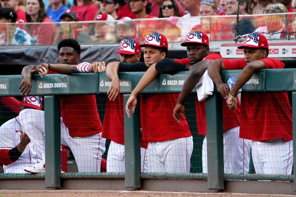 From let: Cincinnati Reds pitchers Justin Dunn, Vladimir Gutierrez, Luis Castillo (58), outfielder Aristides Aquino and pitcher Alexis Diaz, watch the game during the first inning of a baseball game against the New York Mets, Monday, July 4, 2022, at Great American Ball Park in Cincinnati.