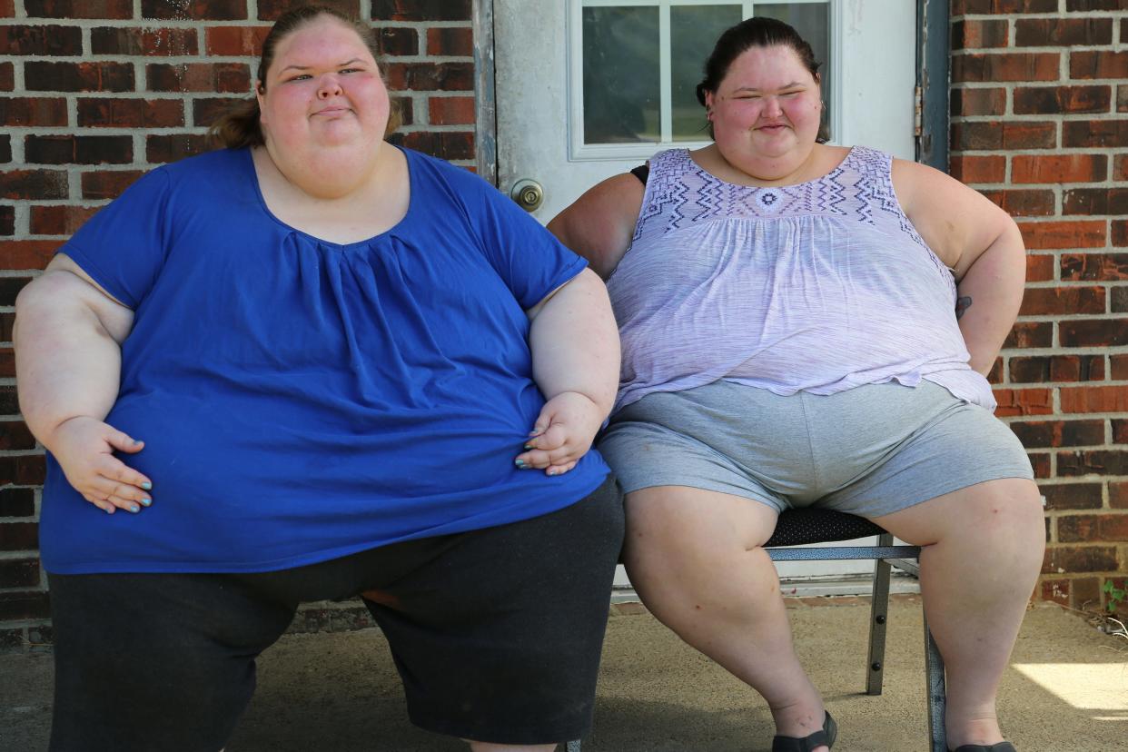 Tammy & Amy sit on their front porch.