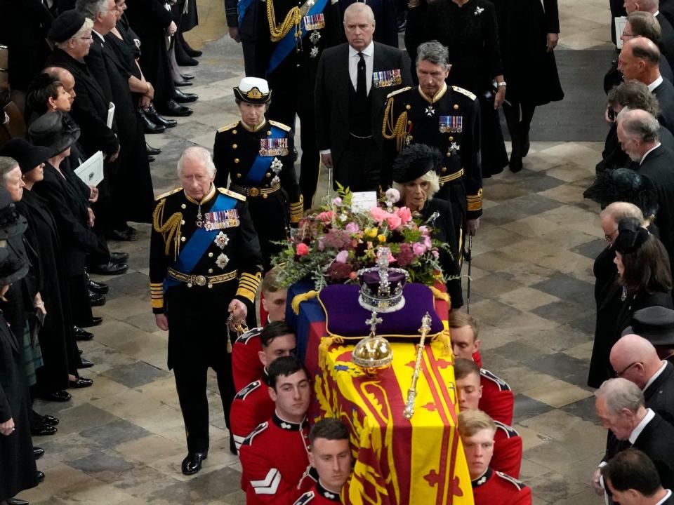 The royal family processes behind the Queen's casket in Westminster Abbey.