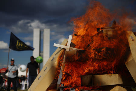 Striking police officers set fire to coffins during a protest by Police officers from several Brazilian states against pension reforms proposed by Brazil's president Michel Temer, in Brasilia, Brazil April 18, 2017. REUTERS/Adriano Machado