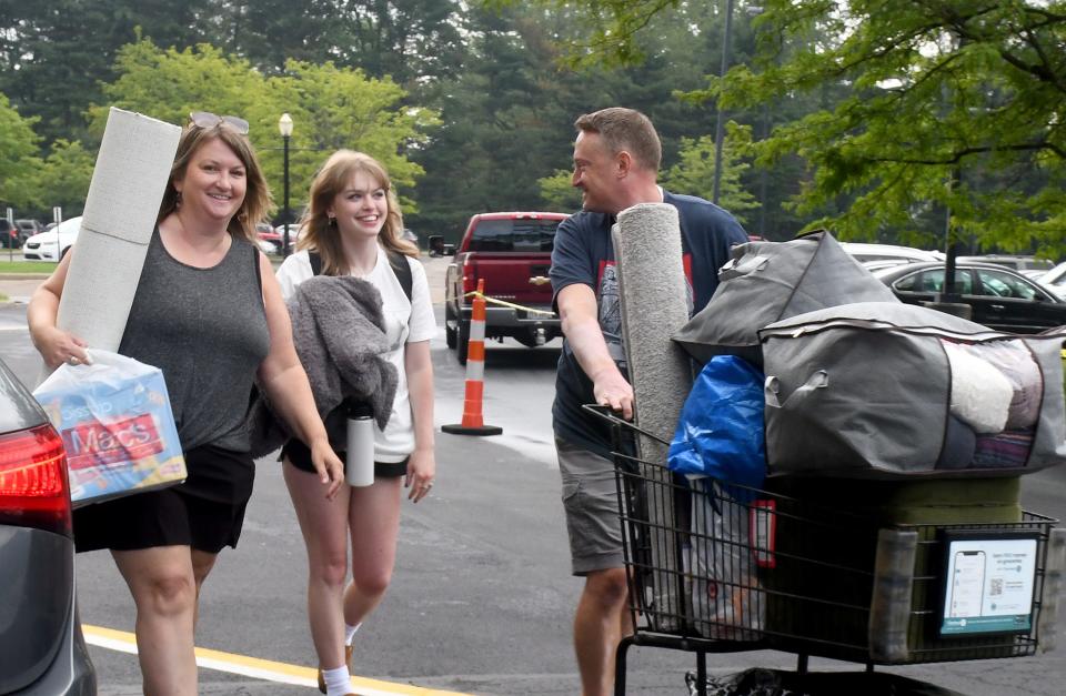 Freshman Ava Wolf of Brecksville gets a hand from parents Karen and Kris while moving into her residence hall at Walsh University in August.