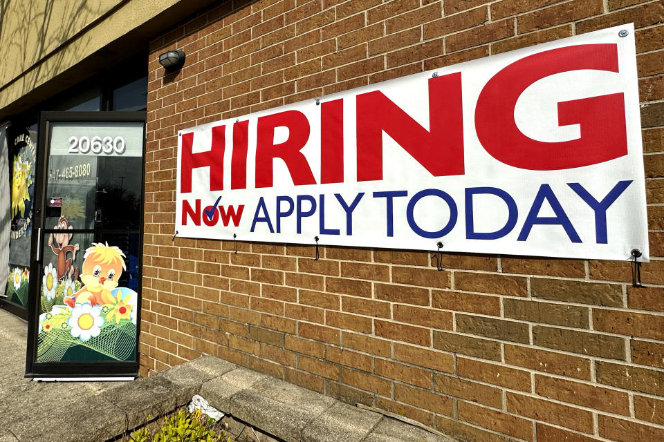 FILE - A hiring sign is displayed in Riverwoods, Ill., Tuesday, April 16, 2024. The Biden administration has finalized a new rule set to make millions of more salaried workers eligible for overtime pay in the U.S. The move marks the largest expansion in federal overtime eligibility seen in decades. (AP Photo/Nam Y. Huh, File)