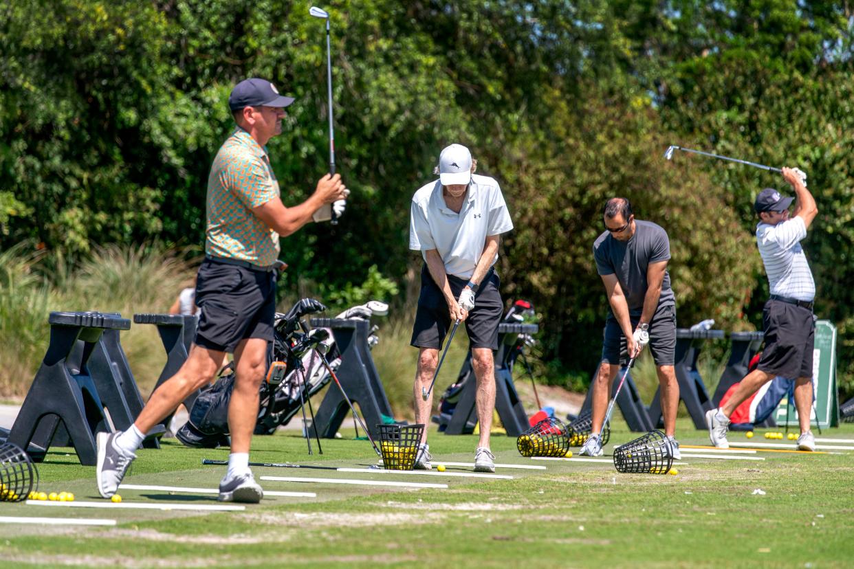 Golfers practice on the driving range at Osprey Point Golf Course on April 5, 2024 in Boca Raton, Florida.