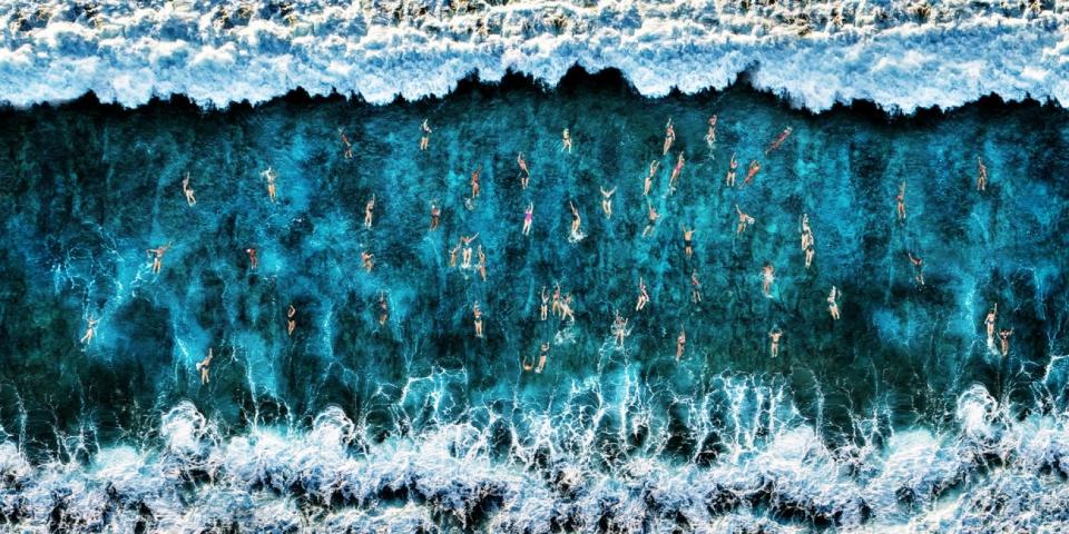 Drone Photo Awards, swimmers breaking a wave.