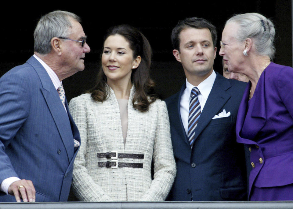 FILE - Denmark's Crown Prince Frederik and his fiancee Mary Donaldson, center, speak with Denmark's Queen Margrethe II and Prince Henrik as they appear on the balcony of the Christian IX Palace at Amalienborg Castle, in Copenhagen, Wednesday, Oct.8, 2003. As a teenager, Crown Prince Frederik felt uncomfortable being in the spotlight, and pondered whether there was any way he could avoid becoming king. All doubts have been swept aside as the 55-year-old takes over the crown on Sunday, Jan. 14, 2024 from his mother, Queen Margrethe II, who is breaking with centuries of Danish royal tradition and retiring after a 52-year reign. (AP Photo/Heribert Proepper, File)