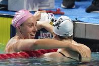Abbey Weitzeil, left, talks with Gretchen Walsh, right, after winning the 50-meter freestyle at the U.S. national championships swimming meet, Saturday, July 1, 2023, in Indianapolis. (AP Photo/Darron Cummings)