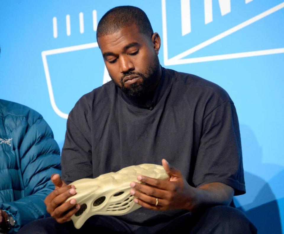 Ye, holding a Yeezy x Adidas design in November 2019, alleged in social media posts this month that Adidas has tried to buy him out of the Yeezy brand. He is under contract with the company until 2026. (Photo by Brad Barket/Getty Images for Fast Company)