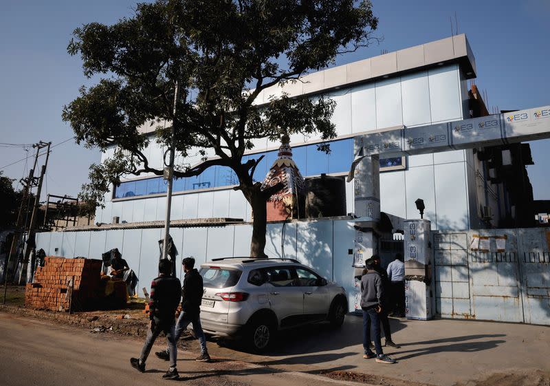 FILE PHOTO: People stand outside the Maiden Pharmaceuticals plant in Sonipat in the northern state of Haryana, India,