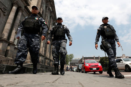 Police officers walk on the main square a day after local election in Toluca, Mexico June 5, 2017. REUTERS/Carlos Jasso