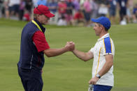 Team USA captain Steve Stricker shakes hands with Team Europe's Rory McIlroy during a Ryder Cup singles match at the Whistling Straits Golf Course Sunday, Sept. 26, 2021, in Sheboygan, Wis. (AP Photo/Jeff Roberson)