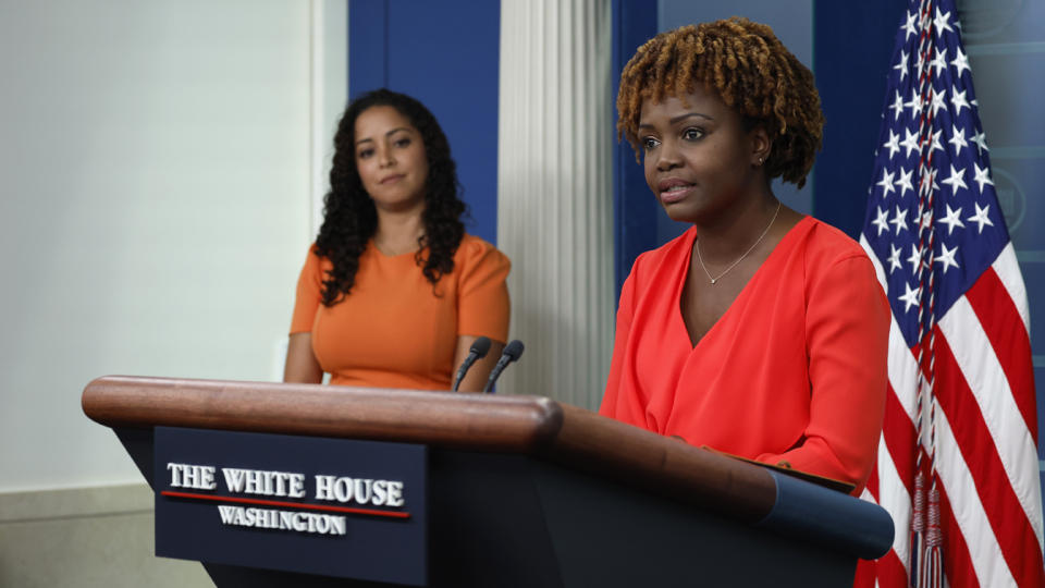 White House press secretary Karine Jean-Pierre stands at a podium.