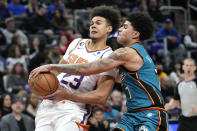 Detroit Pistons guard Killian Hayes (7) defends Phoenix Suns forward Cameron Johnson (23) in the first half of an NBA basketball game in Detroit, Saturday, Feb. 4, 2023. (AP Photo/Paul Sancya)