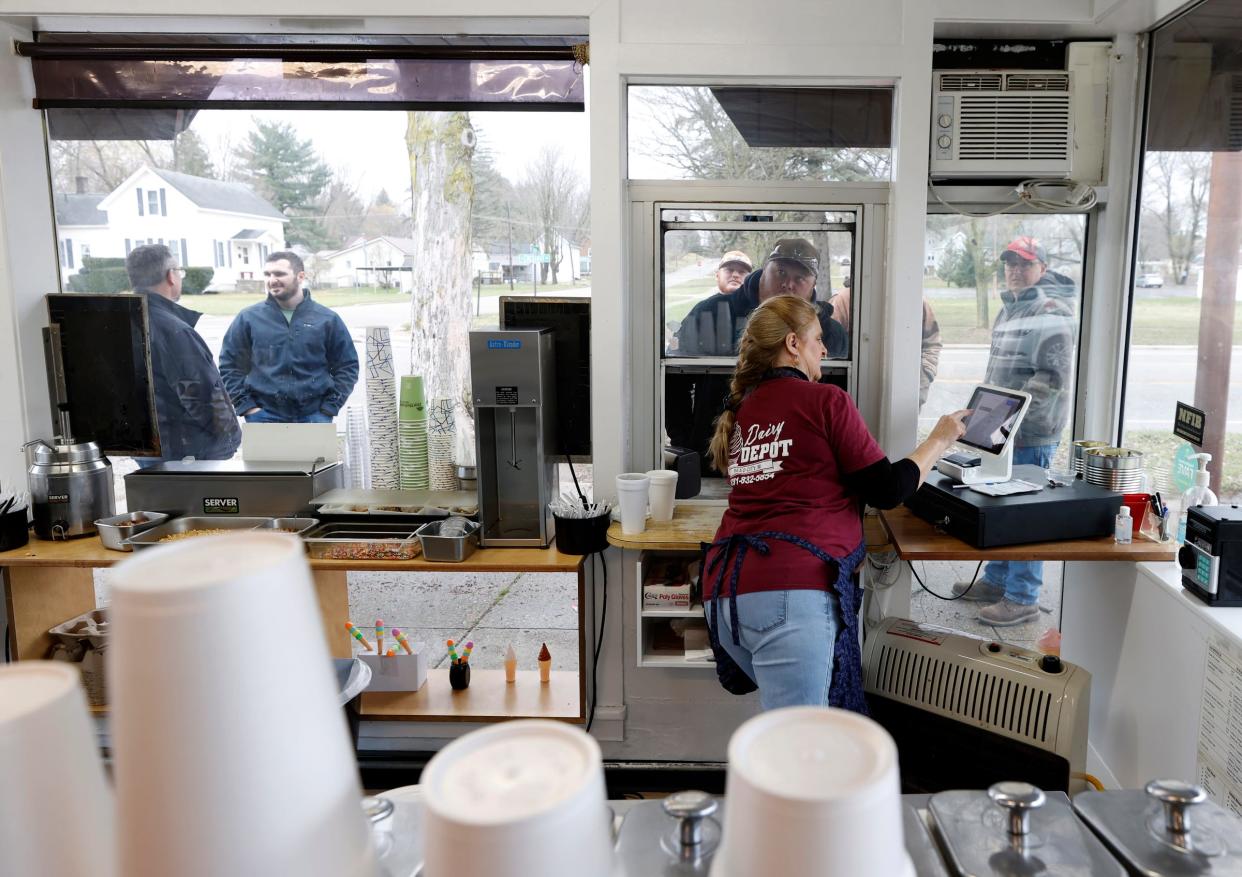 Teri Dudley, 63 of Paris, Michigan, takes customers' lunch orders at the Dairy Depot in Reed City, on Thursday, April 3, 2024, as she has since 1980. Recently, she found herself in the center of a battle in Reed City to protect this business. In June 2023, the ice cream store's owner was approached by land developers who offered to relocate it to build an unnamed retail store in its place. City residents discovered the developers wanted to construct a Dollar General, the second in the city, and the Depot has been a landmark for the city's residents.