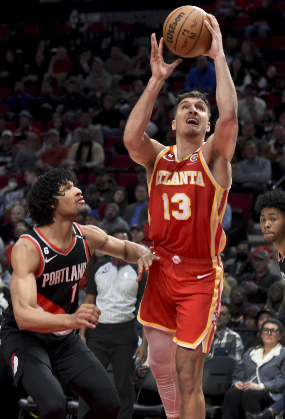 Atlanta Hawks guard Bogdan Bogdanovic, right, looks to shoot over Portland Trail Blazers guard Shaedon Sharpe, left, during the first half of an NBA basketball game in Portland, Ore., Monday, Jan. 30, 2023. (AP Photo/Steve Dykes)