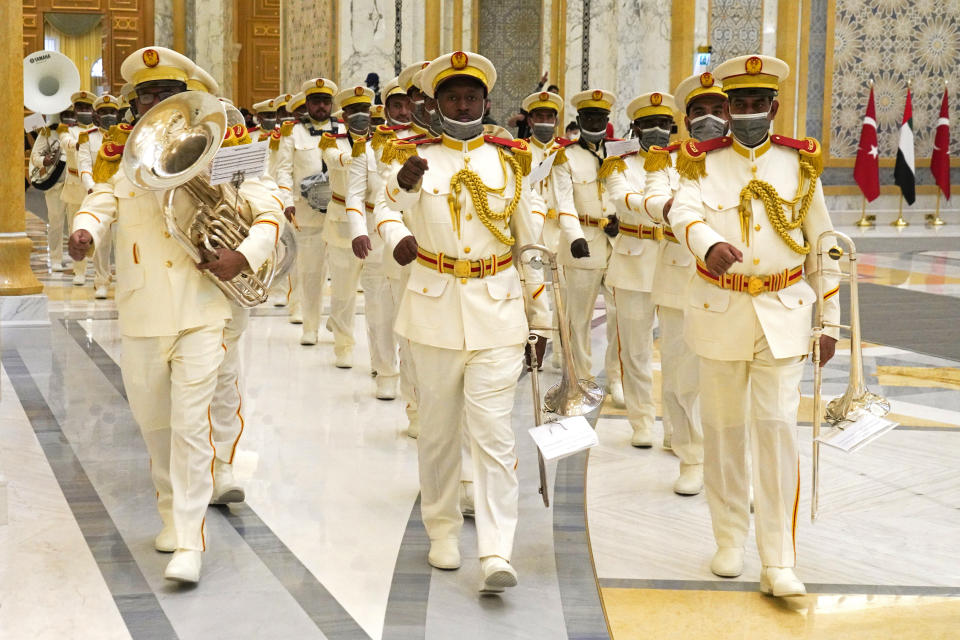 An Emirati military band marches ahead of a visit by Turkish President Recep Tayyip Erdogan at Qasr Al-Watan in Abu Dhabi, United Arab Emirates, Monday, Feb. 14, 2022. Erdogan traveled Monday to the United Arab Emirates, a trip signaling a further thaw in relations strained over the two nations' approaches to Islamists in the wake of the 2011 Arab Spring. (AP Photo/Jon Gambrell)