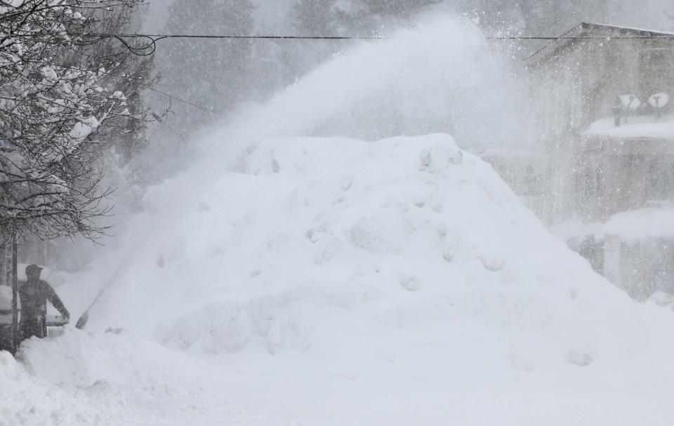 A person uses a snowblower during a powerful multiple day winter storm in the Sierra Nevada mountains on March 03, 2024 in Truckee, California (Getty Images)