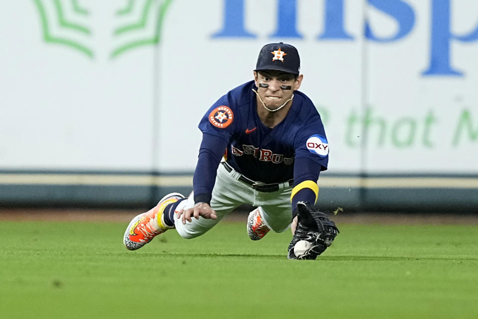 Houston Astros center fielder Mauricio Dubón dives while catching a fly ball by Kansas City Royals' Drew Waters during the fourth inning of a baseball game Sunday, Sept. 24, 2023, in Houston. (AP Photo/David J. Phillip)