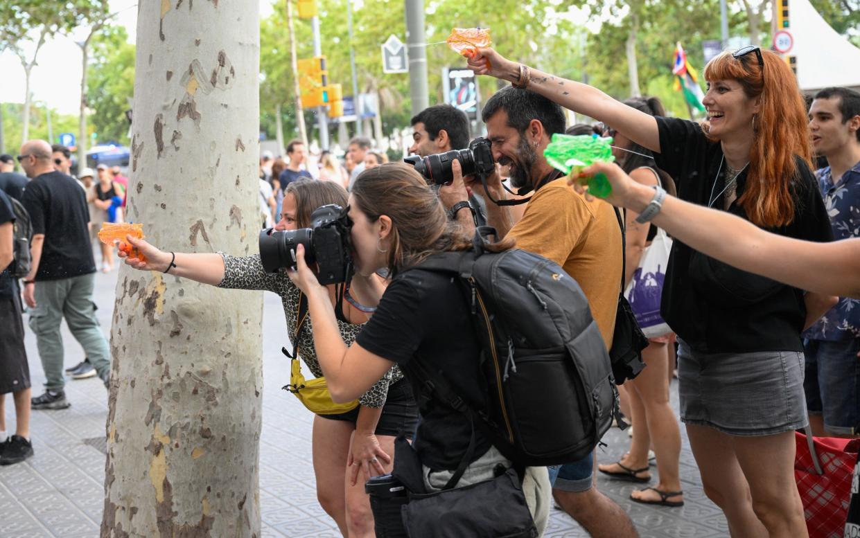 In July, demonstrators in Barcelona squirted tourists with water pistols