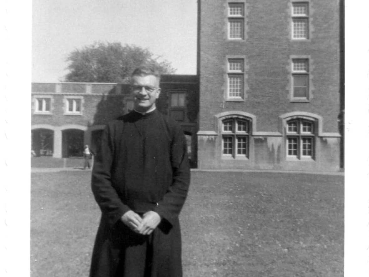George Epoch, standing in front of Loyola College in 1957, was among 27 priests accused of sexually abusing minors named in a list made public Monday by the Jesuits of Canada.  (Submitted by Dorio Lucich - image credit)