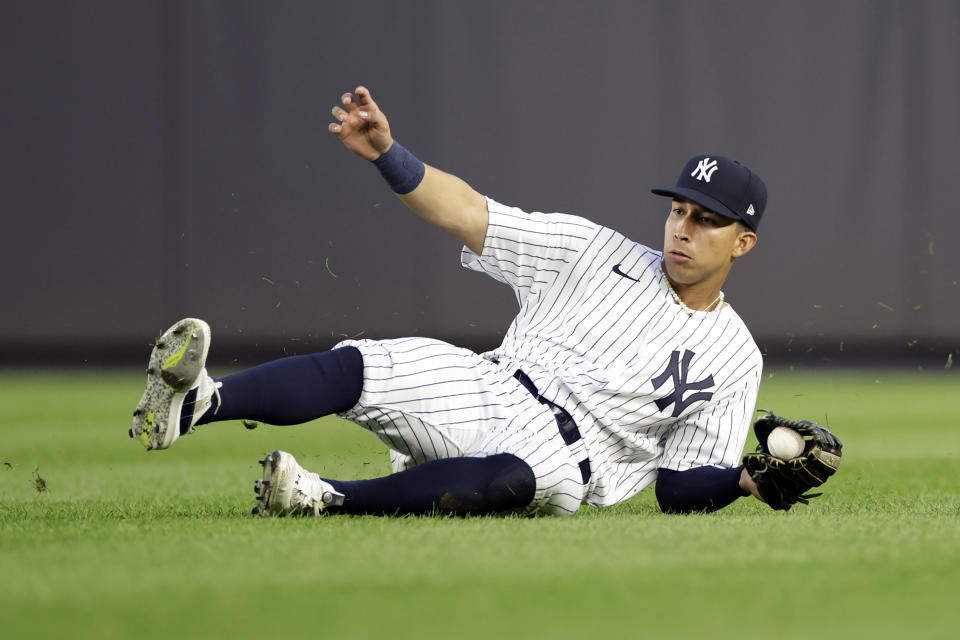 New York Yankees right fielder Oswaldo Cabrera makes a catch on a fly ball hit by Minnesota Twins' Gio Urshela during the 11th inning of the first baseball game of a doubleheader Wednesday, Sept. 7, 2022, in New York. (AP Photo/Adam Hunger)