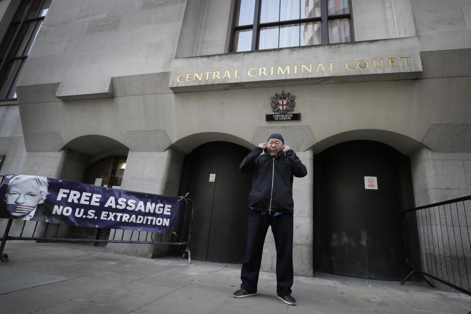 Chinese contemporary artist and activist Ai Weiwei conducts a silent protest outside the Old Bailey in support of Julian Assange's bid for freedom during his extradition hearing, in London, Monday, Sept. 28, 2020. (AP Photo/Kirsty Wigglesworth)