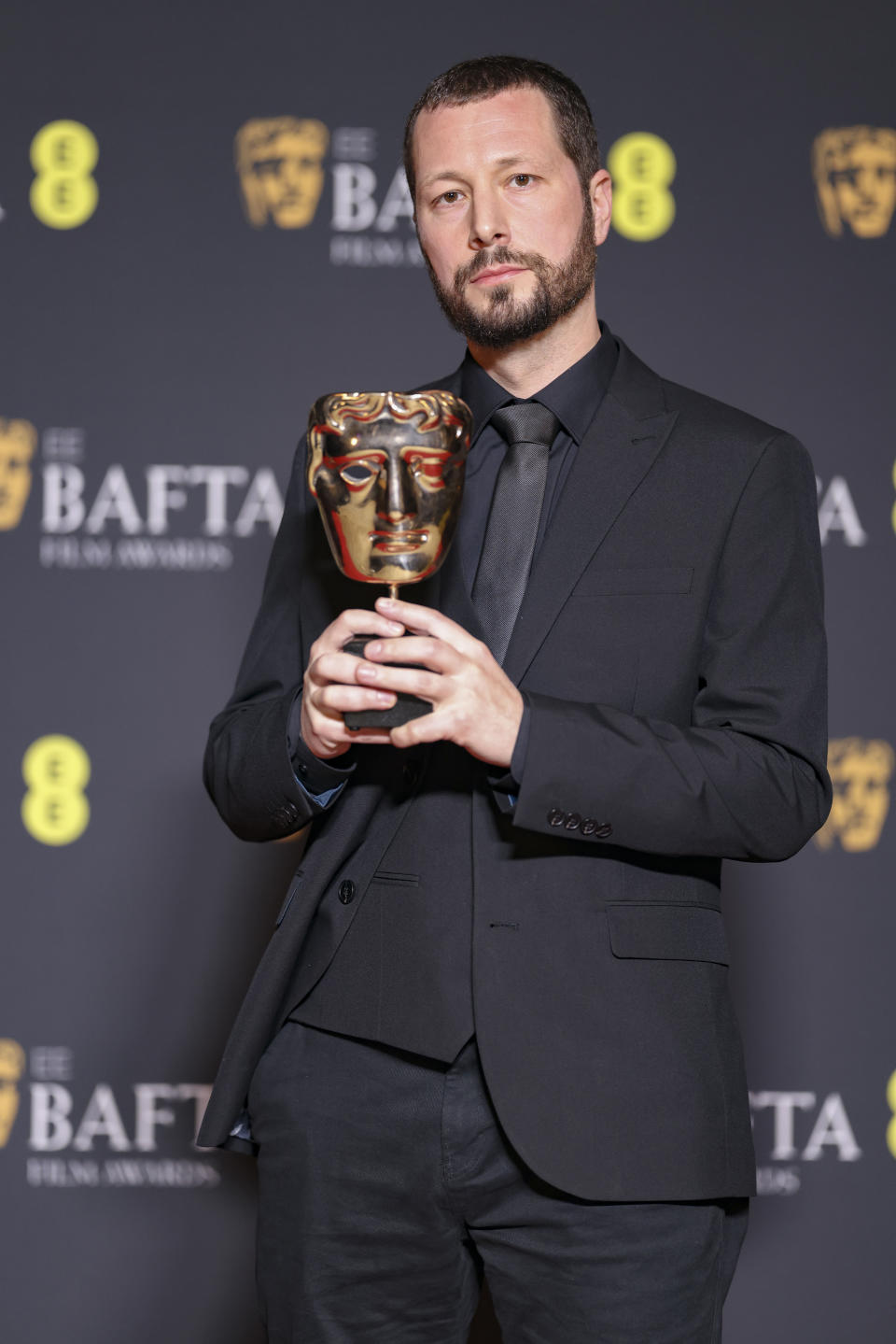Director, producer and Associated Press journalist Mstyslav Chernov, winner of the documentary award for '20 Days in Mariupol', poses for photographers at the 77th British Academy Film Awards, BAFTA's, in London, Sunday, Feb. 18, 2024. (Photo by Vianney Le Caer/Invision/AP)
