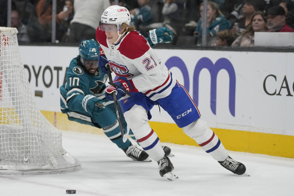 Montreal Canadiens defenseman Kaiden Guhle (21) skates with the puck against San Jose Sharks left wing Anthony Duclair during the first period of an NHL hockey game in San Jose, Calif., Friday, Nov. 24, 2023. (AP Photo/Jeff Chiu)