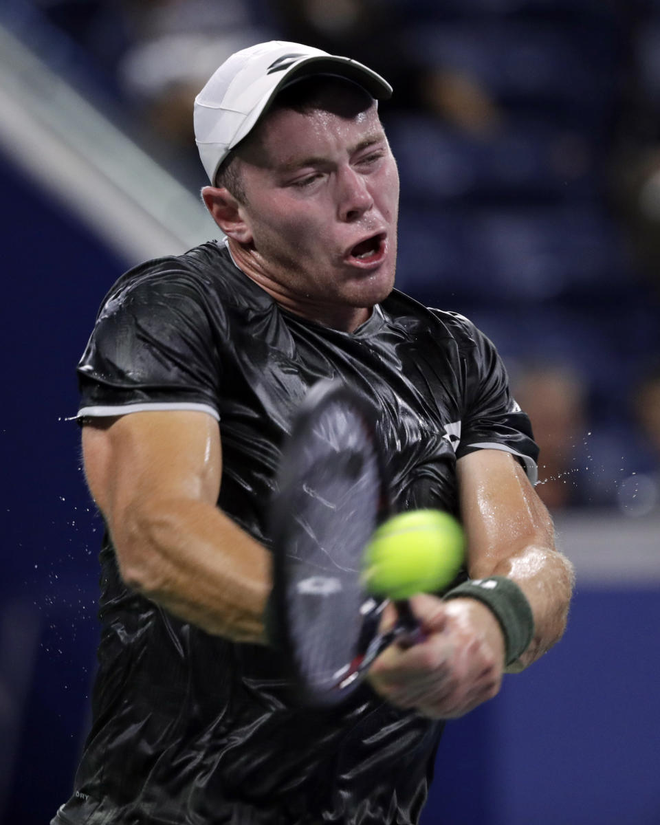 Dominik Koepfer, of Germany, returns a shot to Reilly Opelka, of the United States, during the second round of the U.S. Open tennis tournament Wednesday, Aug. 28, 2019, in New York. (AP Photo/Adam Hunger)