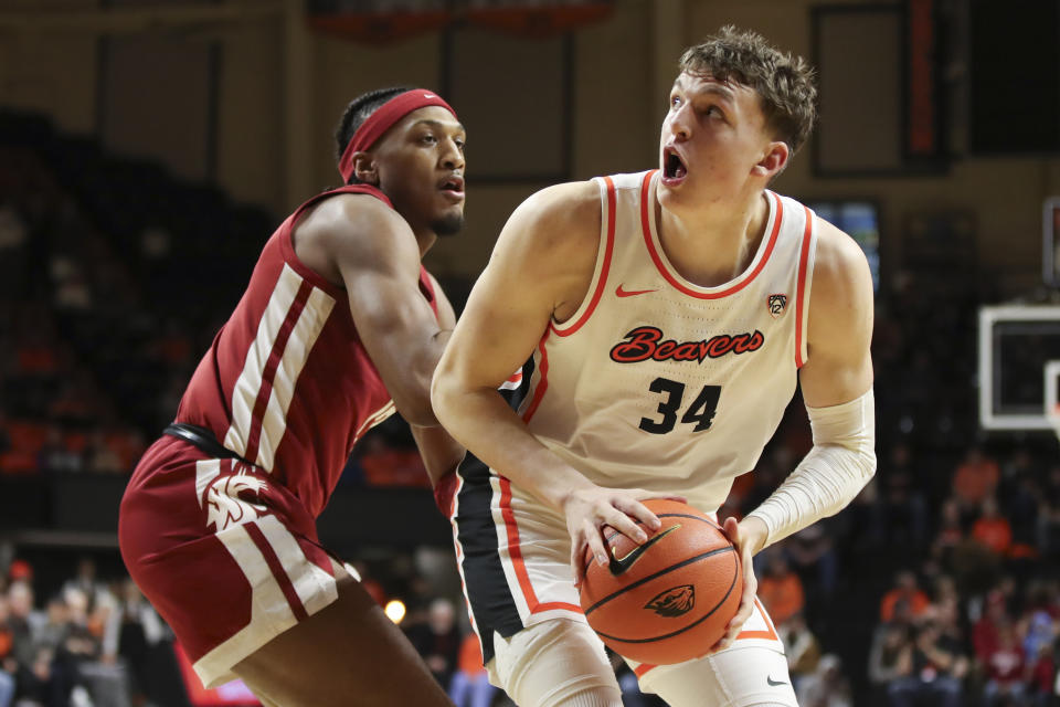 Oregon State forward Tyler Bilodeau (34) looks to shoot as Washington State forward Isaac Jones defends during the first half of an NCAA college basketball game Thursday, Feb. 8, 2024, in Corvallis, Ore. (AP Photo/Amanda Loman)