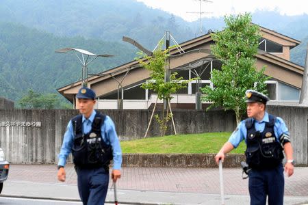 Police officers are seen in front of a facility for the disabled where at least 19 people were killed and as many as 20 wounded by a knife-wielding man, in Sagamihara, Kanagawa prefecture, Japan, in this photo taken by Kyodo July 26, 2016. Mandatory credit Kyodo/via REUTERS