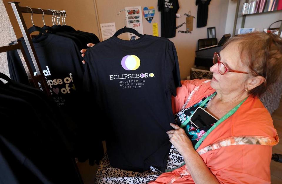 Susan Shewmake, owner of Finished Seams boutique in downtown Hillsboro, shows one of the t-shirts for sale at her shop on Thursday, February 22, 2024.