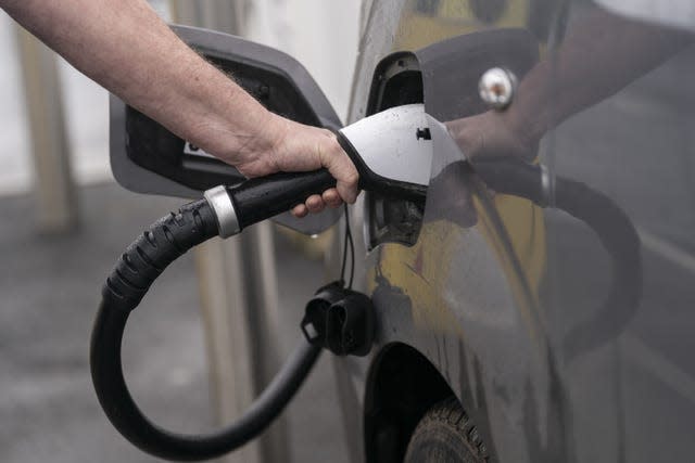 An electric vehicle being charged at a charging station 