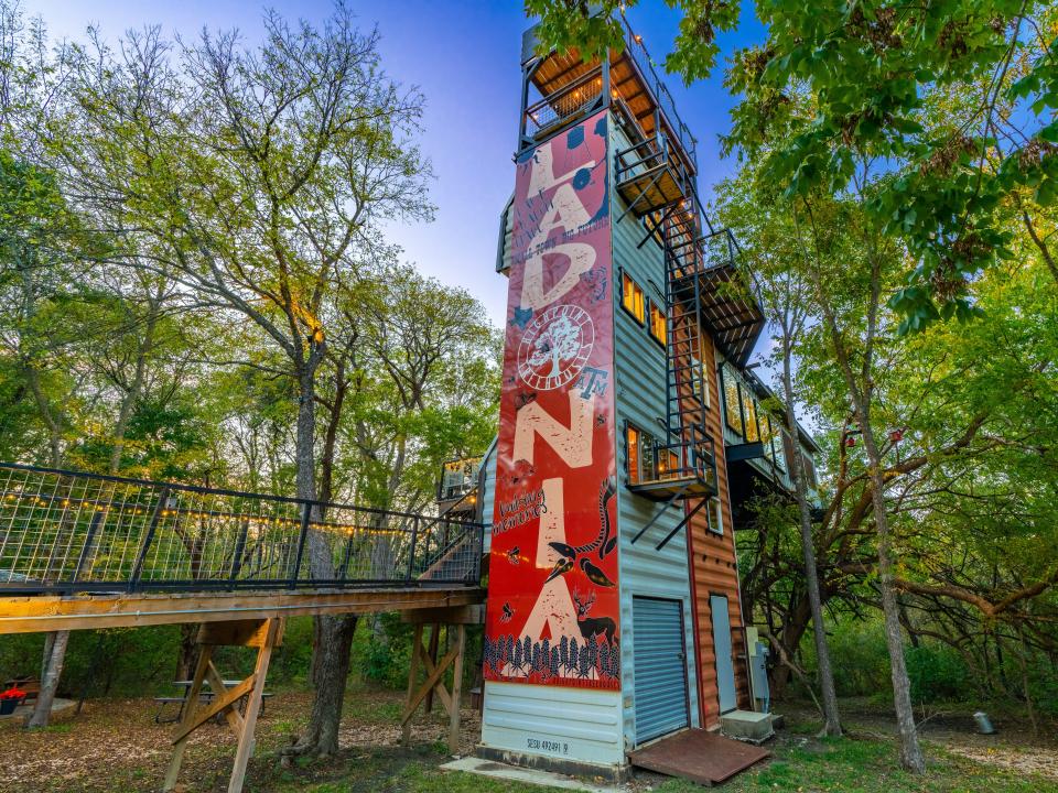 Taylor's daughter, Katie, painted a mural on the side of the shipping container treehouse.