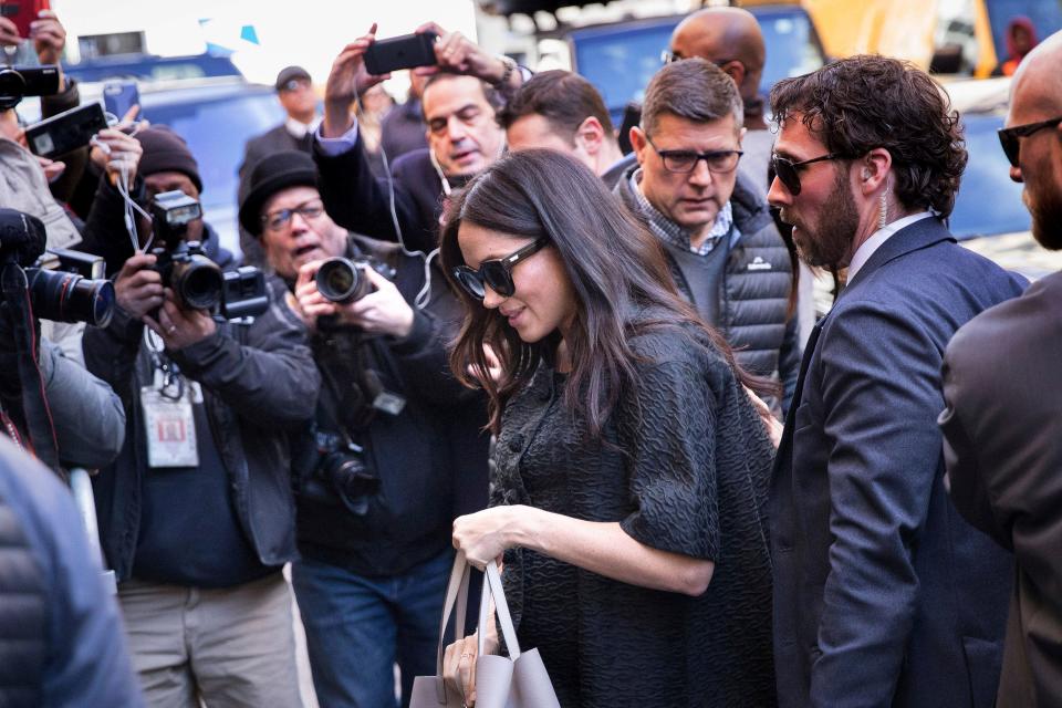 Duchess Meghan of Sussex, surrounded by media and security, arrives for her baby shower at the Mark Hotel, Feb. 19, 2019, in New York.