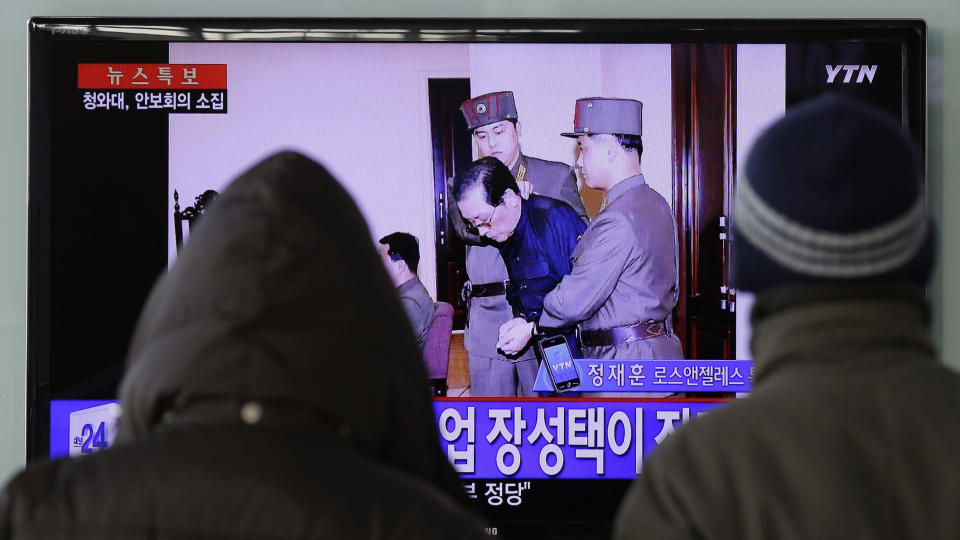 FILE - In this Dec. 13, 2013, file photo, people watch a TV news program showing that North Korean leader Kim Jong Un's uncle Jang Song Thaek, second from right, is escorted by military officers during a trial in Pyongyang, North Korea, at the Seoul Railway Station in Seoul, South Korea. Despite Beijing’s opposition, North Korean leader Kim Jong Un carried out a torrid run of weapons tests while pursuing a nuclear arsenal capable of targeting the U.S. mainland. Kim also executed a slew of senior officials, including his uncle, Jang, who had close ties with China, on treason charges. (AP Photo/Lee Jin-man, File)