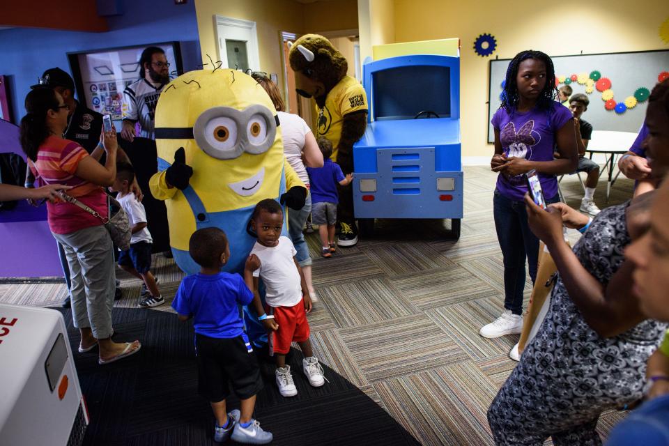 Children get their picture taken with a Minion at the Fascinate-U museum in Fayetteville in August 2015. The museum in 2023 has plans to grow and expand its offerings.