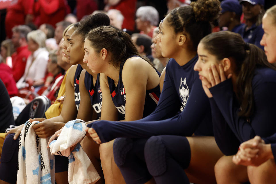 UConn players watch the second half of an NCAA college basketball game against North Carolina State, Sunday, Nov. 12, 2023, in Raleigh, N.C. (AP Photo/Karl B. DeBlaker)