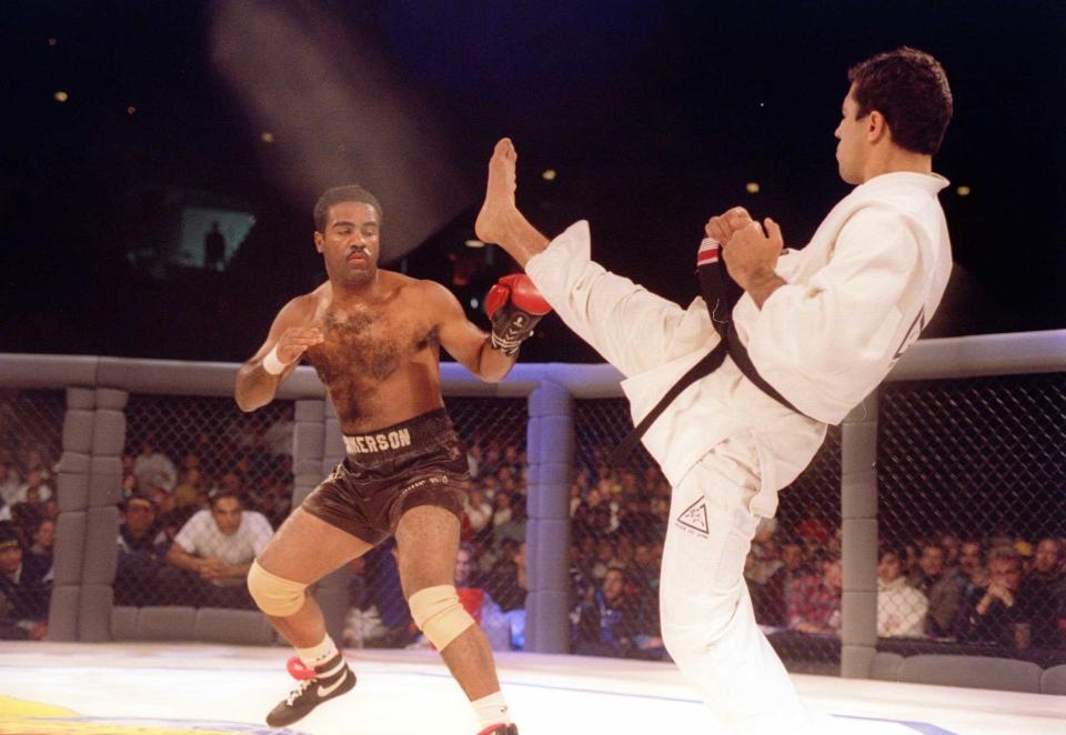 Jiu-Jitsu black belt Royce Gracie kicks at cruiserweight boxer Art Jimmerson during the Ultimate Fighter Championships in Denver, Colorado on Nov. 12, 1993. (Markus Boes/Getty Images)