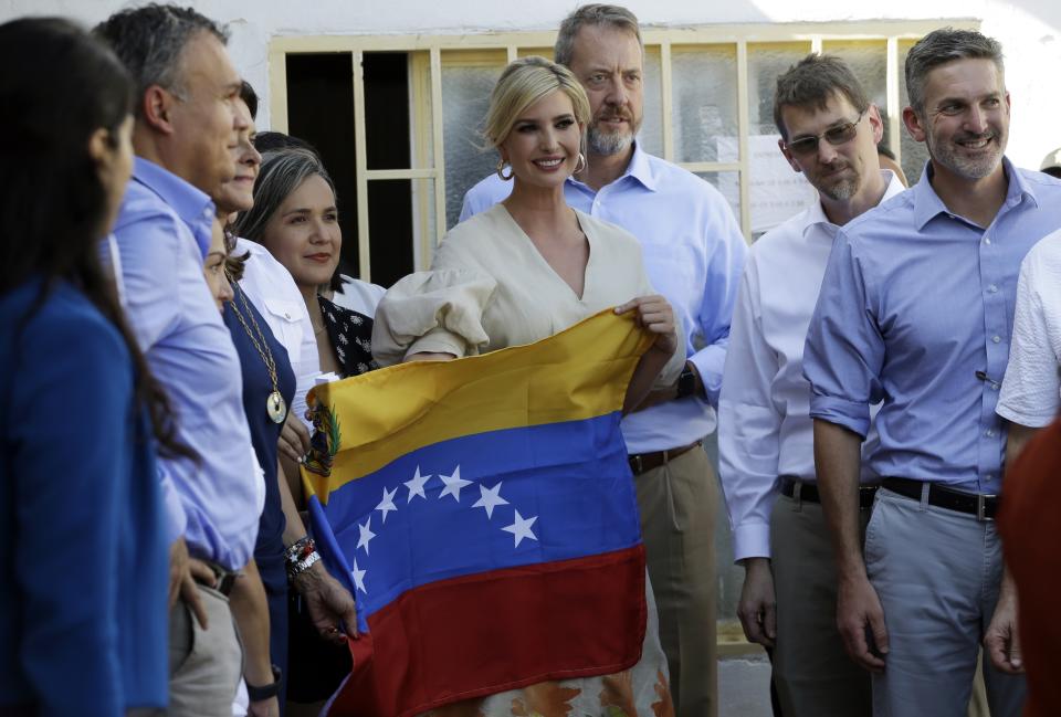 Ivanka Trump, President Donald Trump's daughter and White House adviser, holds a Venezuelan flag at a migrant shelter in La Parada near Cucuta, Colombia, Wednesday, Sept. 4, 2019. Ivanka Trump is kicking off her trip to South America by promoting women's empowerment. (AP Photo/Fernando Vergara)