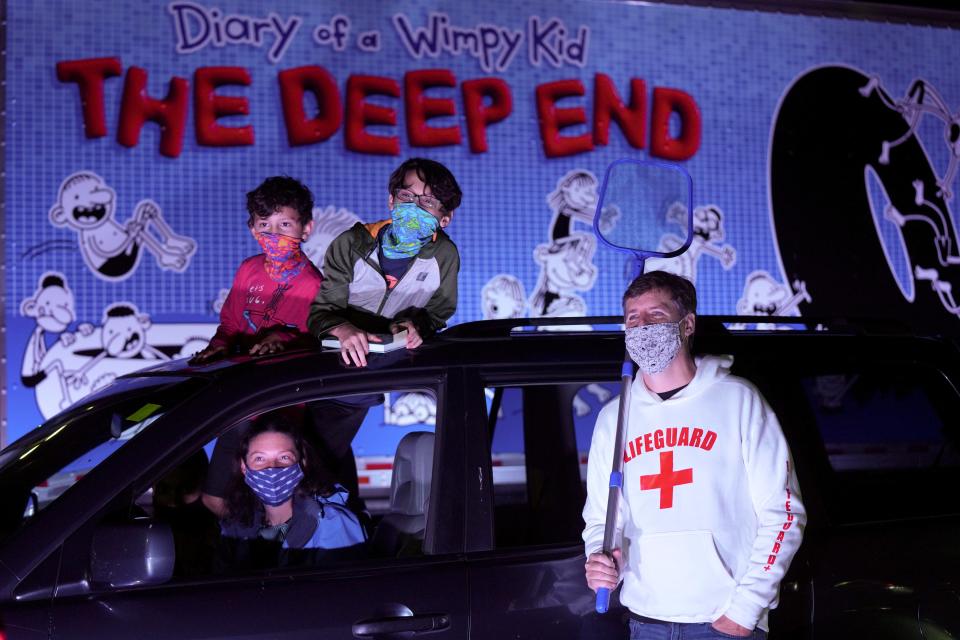 Families attend a drive-thru pool party event to promote Jeff Kinney's latest kids book, "Diary of A Wimpy Kid: The Deep End" on Oct. 26. in Silver Spring, Maryland.