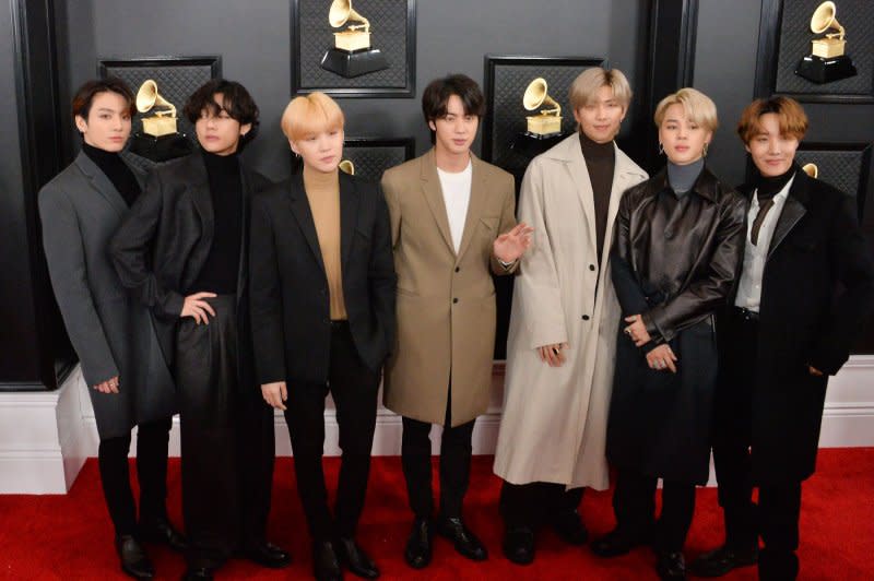 Suga (third from left), pictured with BTS, has started the enlistment process for his mandatory military service in South Korea. File Photo by Jim Ruymen/UPI