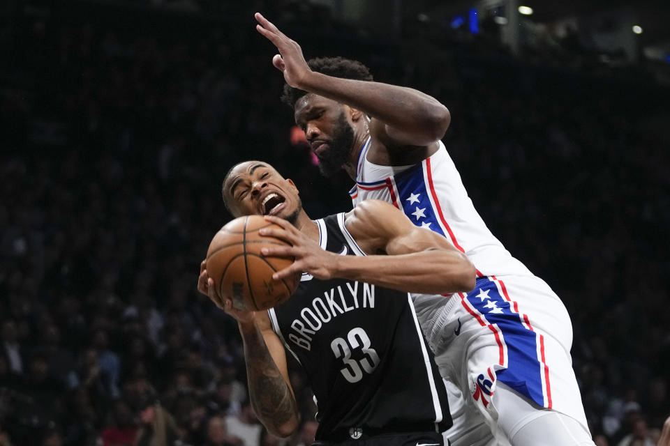 Philadelphia 76ers' Joel Embiid fouls Brooklyn Nets' Nic Claxton (33) during the second half of Game 3 of an NBA basketball first-round playoff series Thursday, April 20, 2023, in New York. (AP Photo/Frank Franklin II)