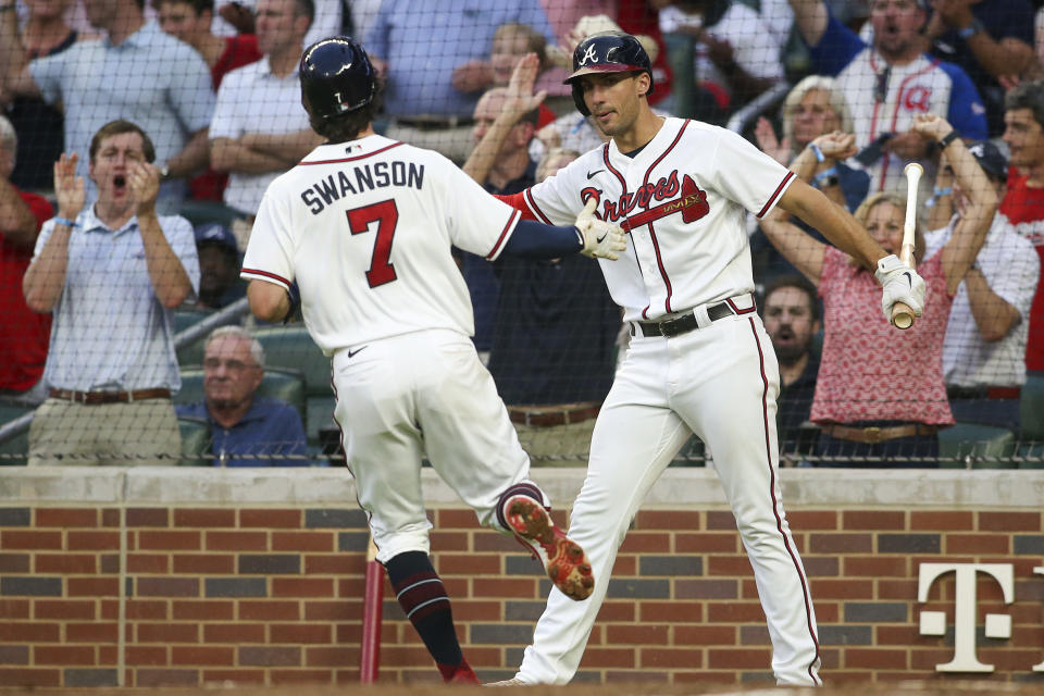 Atlanta Braves' Dansby Swanson (7) celebrates with Matt Olson, right, after scoring against the New York Mets during the third inning of a baseball game Thursday, Aug. 18, 2022, in Atlanta. (AP Photo/Brett Davis)