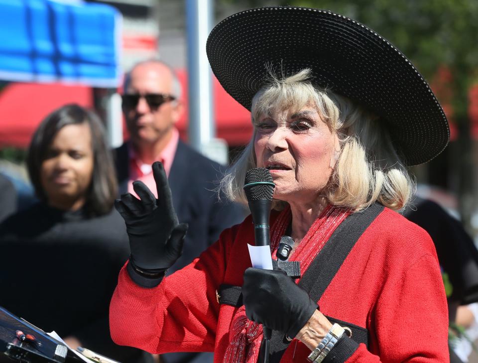 Ophelia Averitt speaks as Akron City Council President Margo Sommerville and Mayor Dan Horrigan listen Saturday.