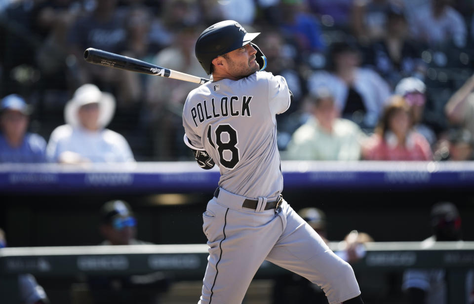 Chicago White Sox's AJ Pollock follows his two-run single off Colorado Rockies relief pitcher Carlos Estevez during the seventh inning of a baseball game Wednesday, July 27, 2022, in Denver. (AP Photo/David Zalubowski)