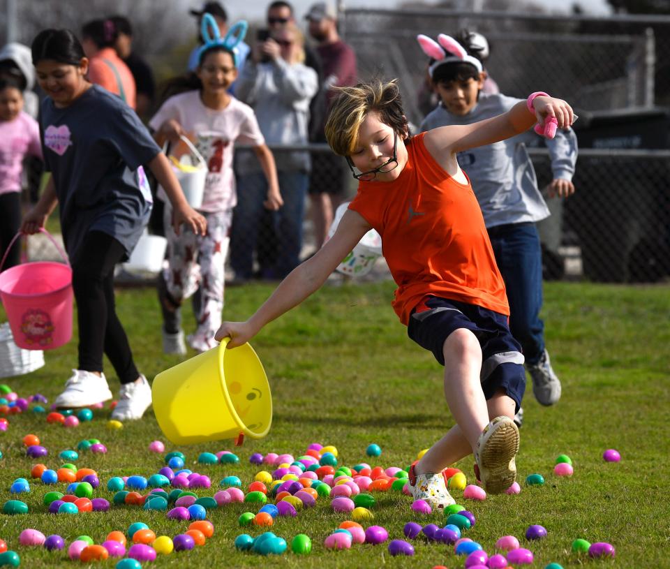 A boy loses his glasses as he runs into the field for the city of Abilene’s Easter Egg Hunt at the Stafford Sports Complex Saturday March 23, 2024.