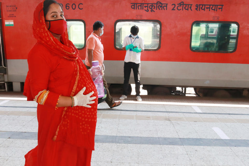 A pregnant women walk   to board a Special AC train for New Delhi after the government eased a nationwide lockdown imposed as a preventive measure against the COVID-19 coronavirus, Howrah rail station in Kolkata on May 12, 2020. (Photo by Debajyoti Chakraborty/NurPhoto via Getty Images)